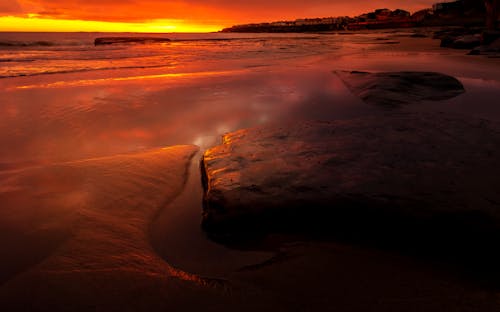 Rocks by the Shore During Sunset 