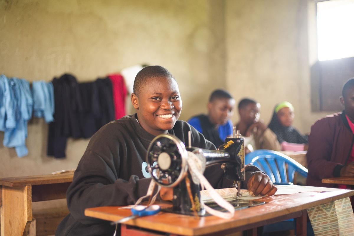 Women in a vocational training class learning to use sewing machines