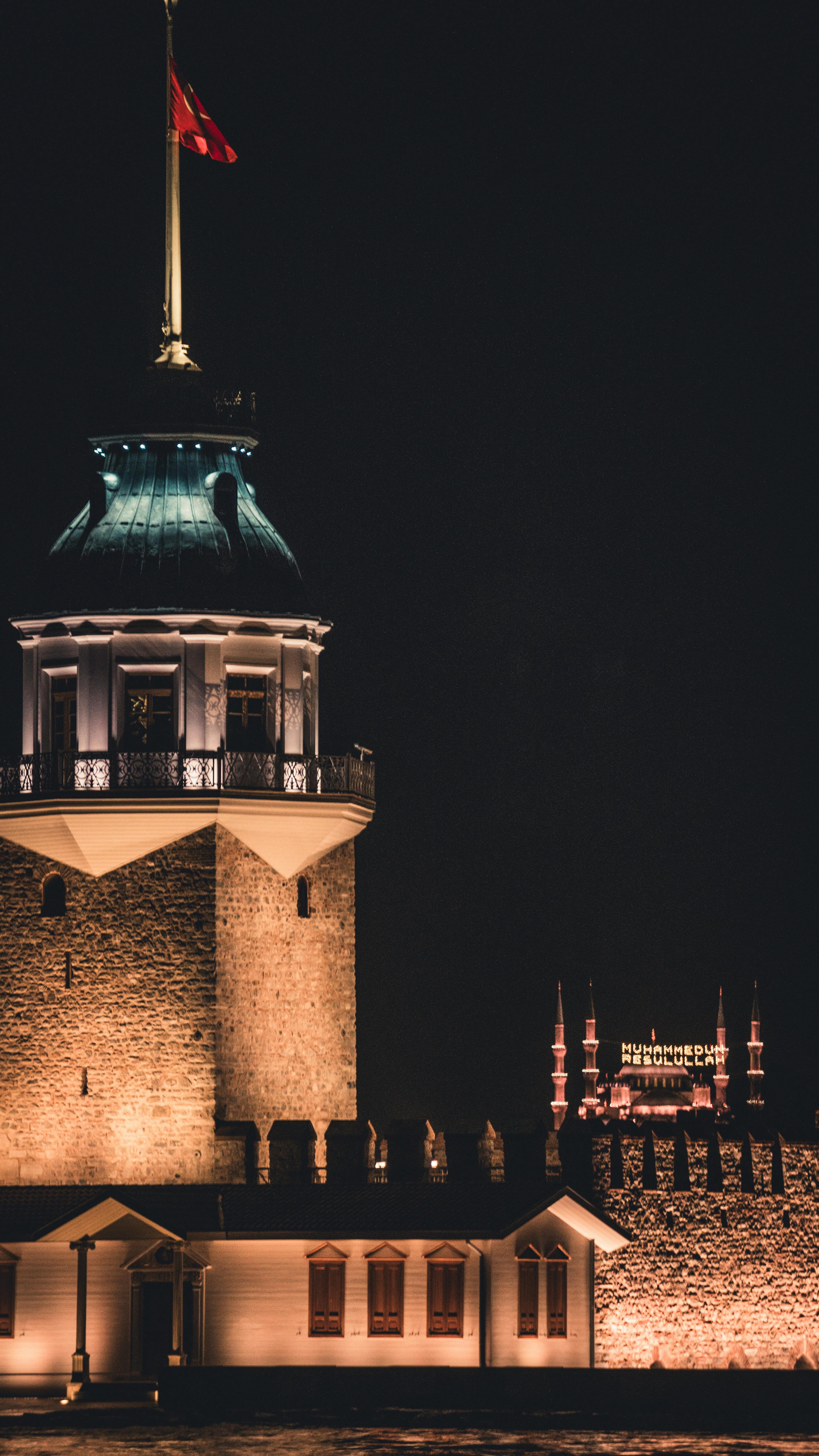 Stunning view of the illuminated Maiden's Tower in Istanbul captured at night.