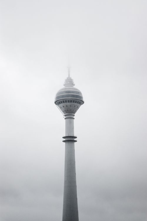 Free A striking vertical shot of Istanbul's iconic TV tower shrouded in clouds. Stock Photo