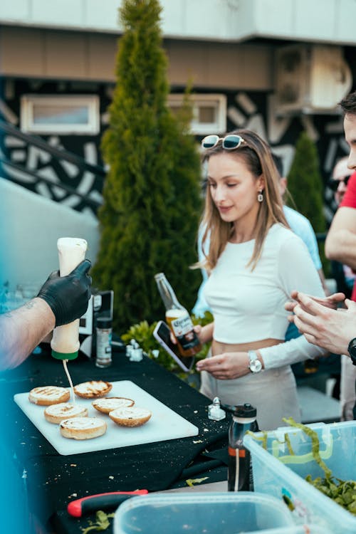 A woman is serving food to people at a party