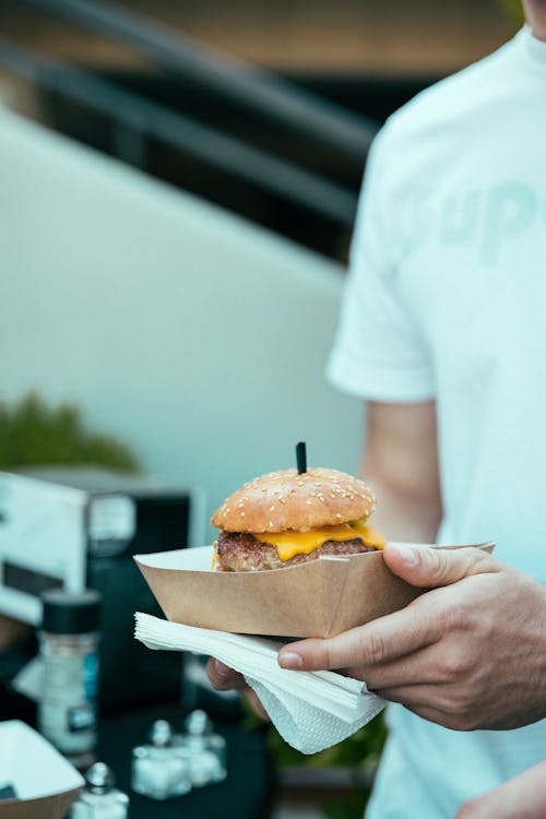 A man holding a burger in his hand