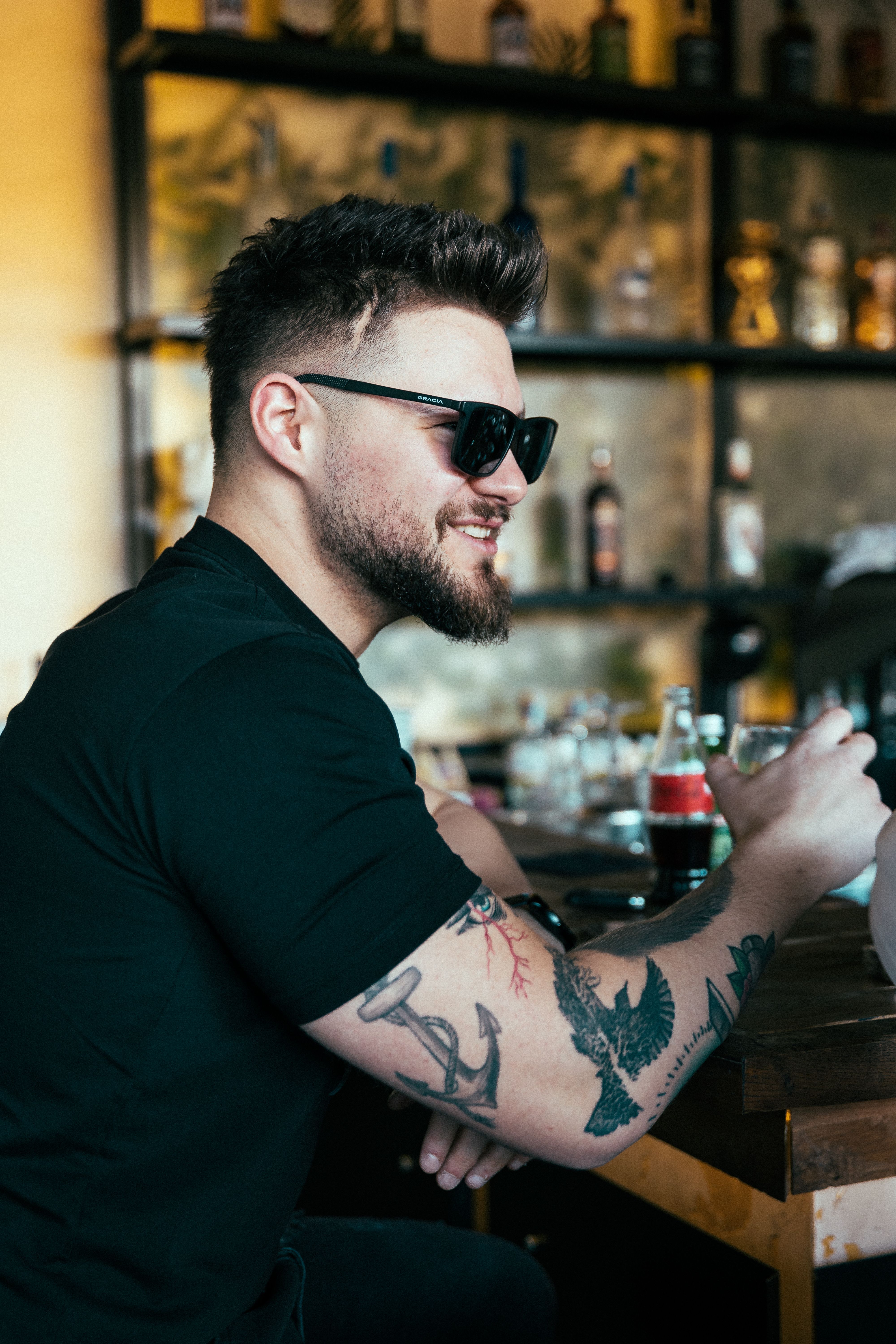 A sunglasses photo at a bar where the eyes stay hidden