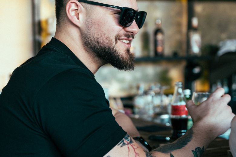 A sunglasses photo at a bar where the eyes stay hidden