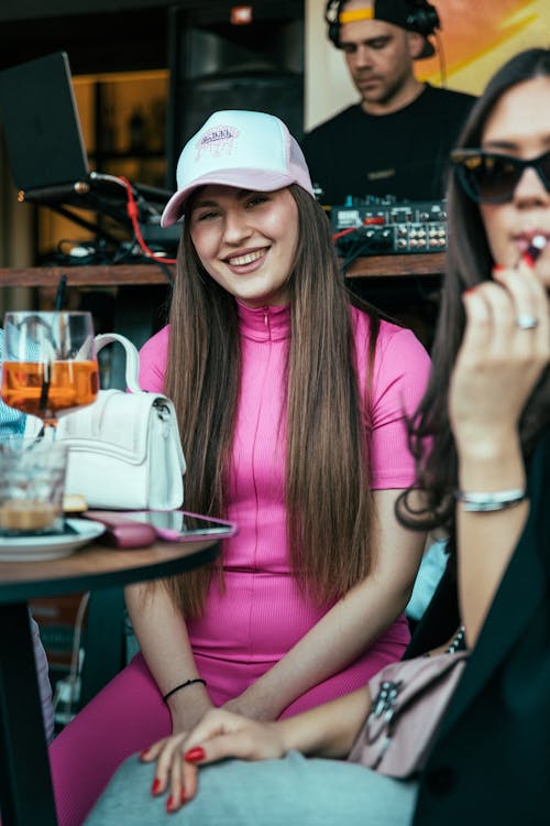 Two women sitting at a table with drinks