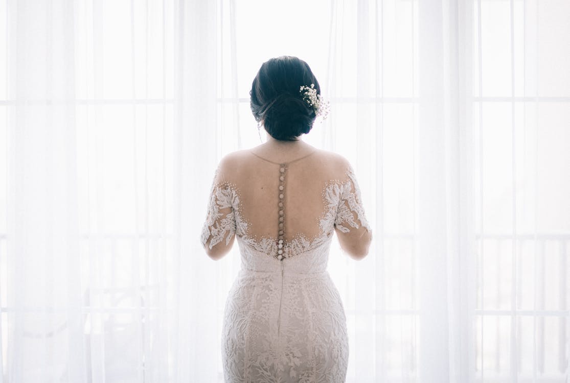 Woman Wearing White Lace Wedding  Dress  Near  White Curtain 