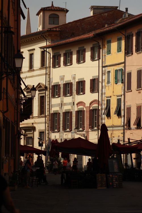 Free A vibrant European street scene with colorful building facades and street life during daytime. Stock Photo