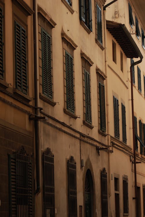 A photo of a street with buildings and shutters