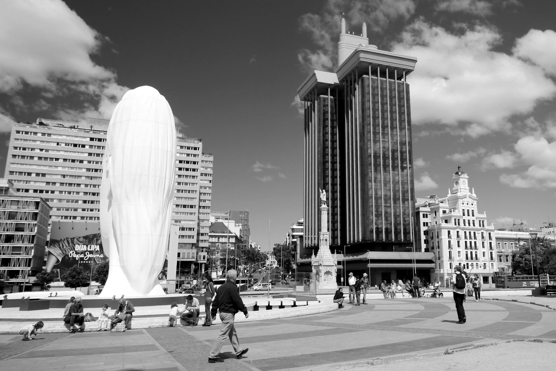 Monochrome view of Plaza de Colón with iconic sculpture and skyline in Madrid, Spain.