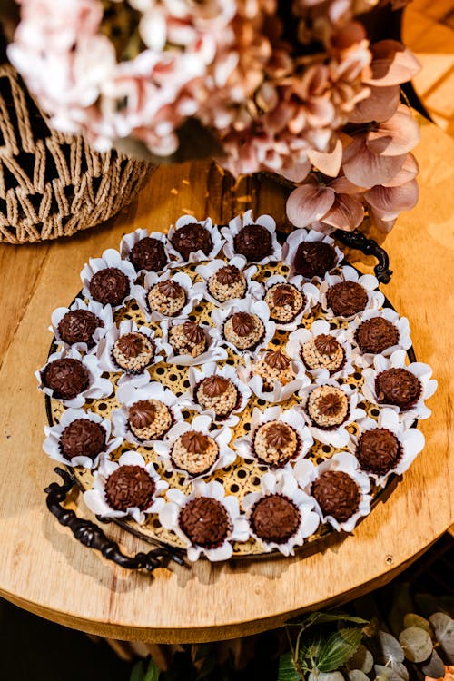 A tray of chocolate covered cookies on a wooden table