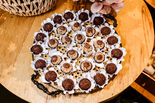 A tray of chocolate covered cookies on a wooden table