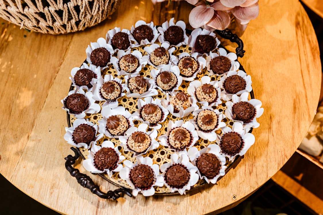A tray of chocolate covered cookies on a wooden table