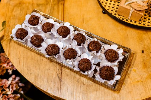 Free Assorted chocolate truffles displayed elegantly on a wooden table. Stock Photo