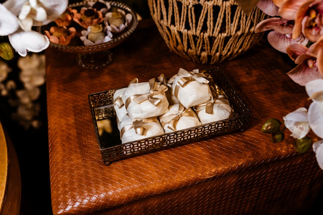 A table with a basket of fruit and flowers