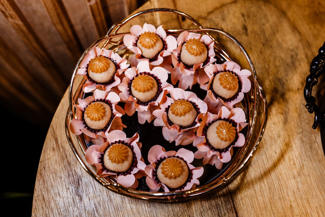 A bowl of chocolate covered strawberries on a wooden table