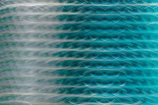 Vibrant abstract artwork featuring a dynamic turquoise steel wave pattern.