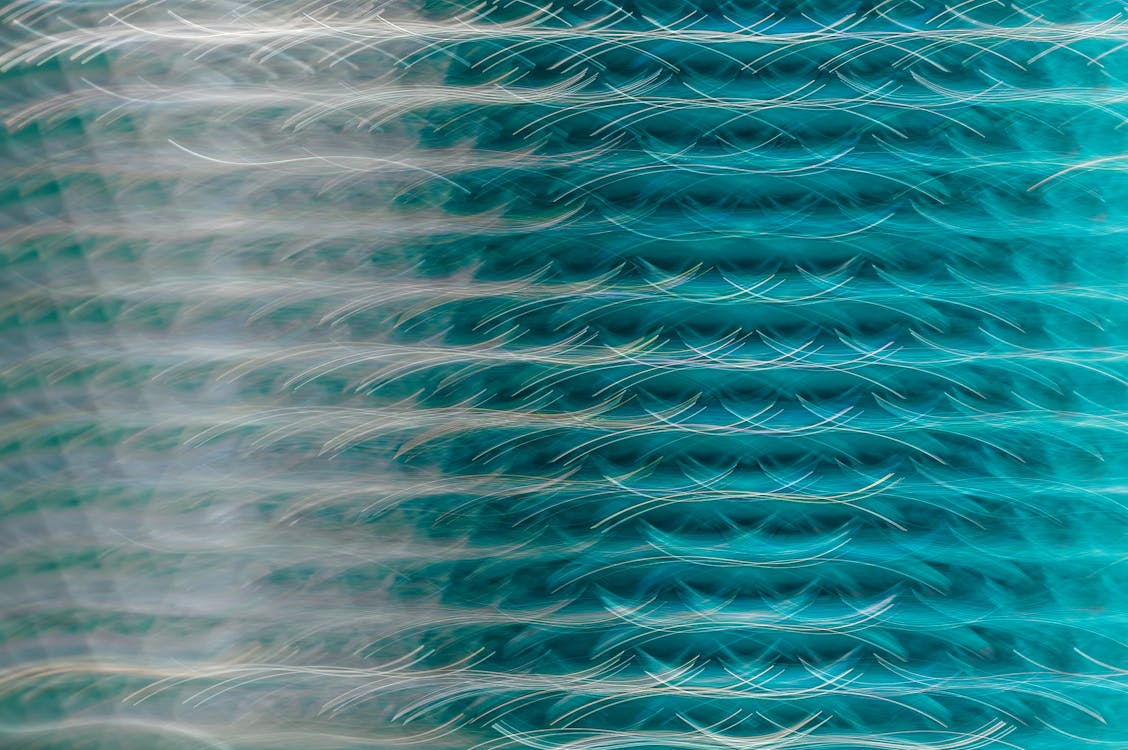 A glass sculpture with waves in blue and white