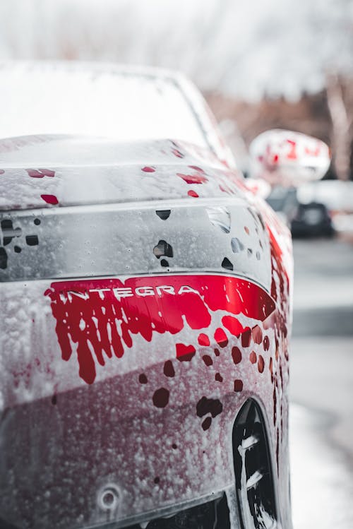 A close up of a car with red paint and blood splatter