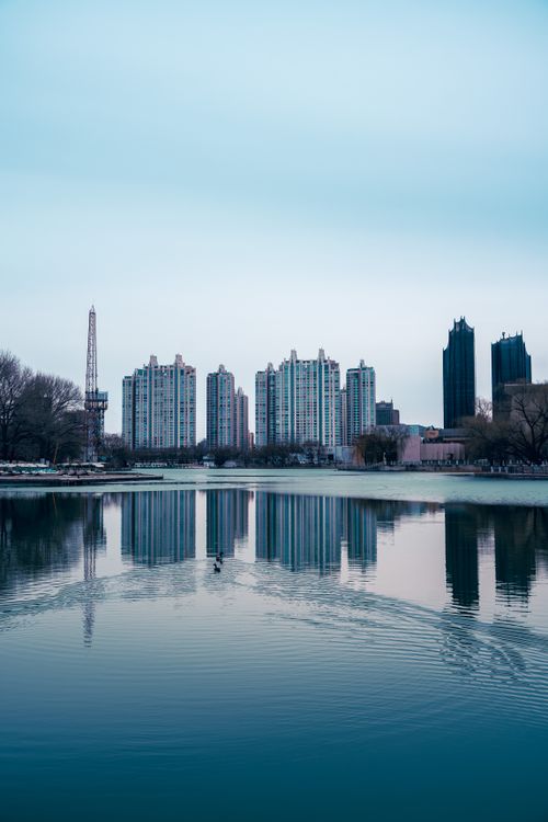 Free Stunning view of Beijing skyline and its reflection on a serene lake, capturing urban architecture. Stock Photo