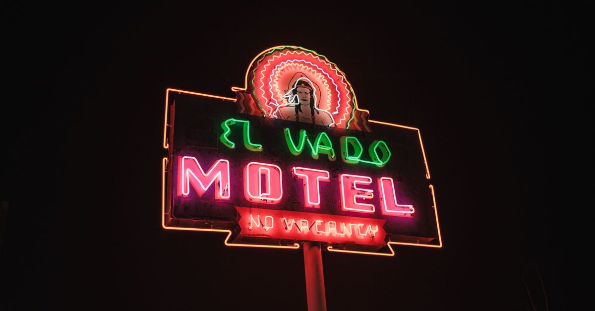 El Vado Motel neon sign glowing brightly in the night sky, showcasing vintage allure.