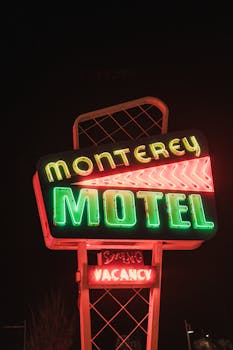 Classic neon sign for Monterey Motel glowing at night, offering vacancy.
