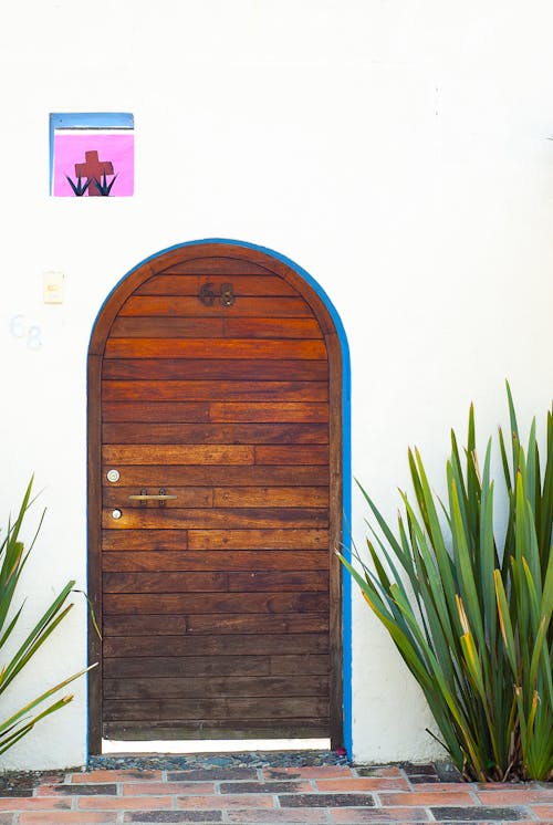 A door with a wooden frame and a blue and white sign