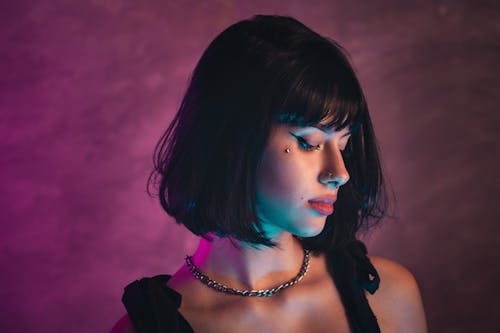 A woman with short hair and a necklace