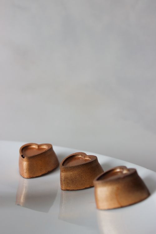 Free Elegant close-up of heart-shaped gourmet chocolates on a white background. Stock Photo