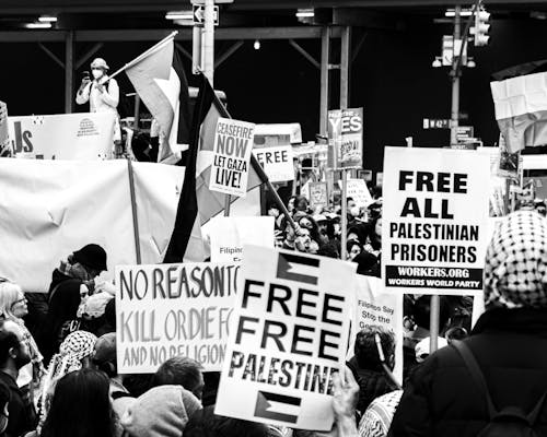 Black and white photo of people holding signs