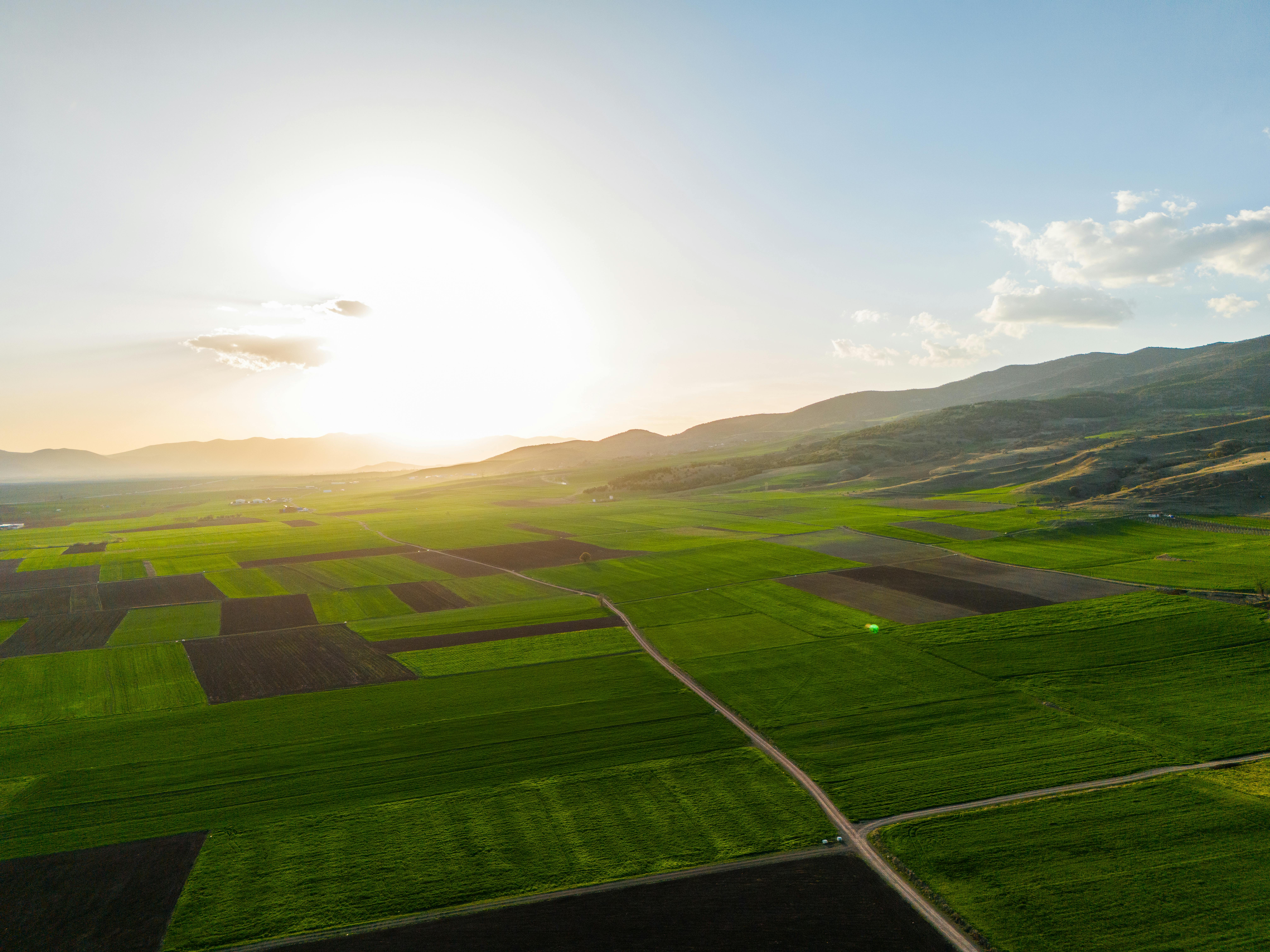 Photo of Green Field Near Mountains · Free Stock Photo