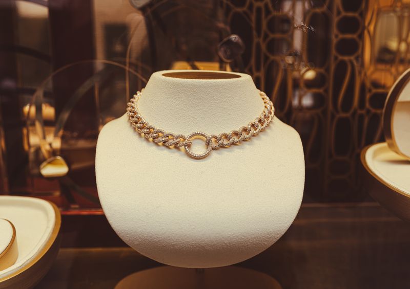Gold chain necklace on display
