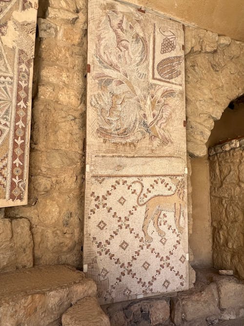 The ancient wall has a mosaic on it