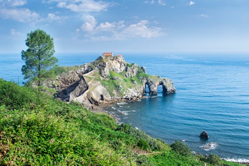 A rocky island with a lighthouse and a cliff