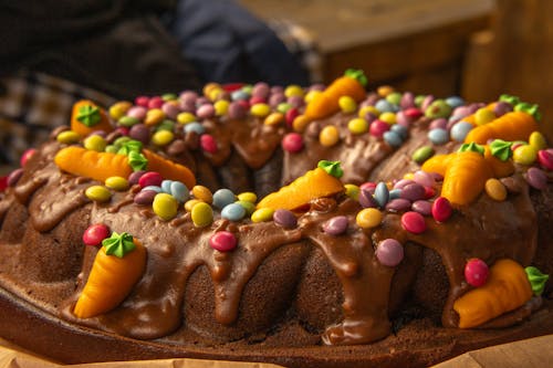 A chocolate cake with chocolate icing and chocolate sprinkles
