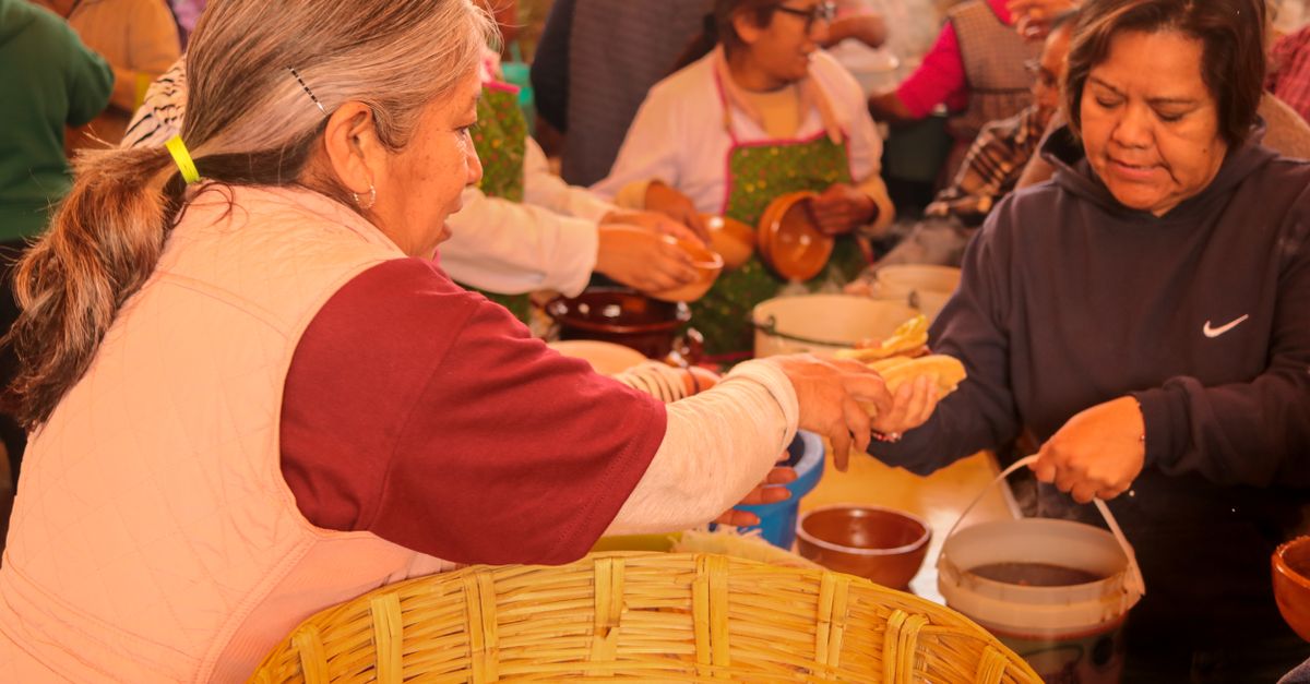 A community food outreach event with volunteers serving meals to locals in Ho