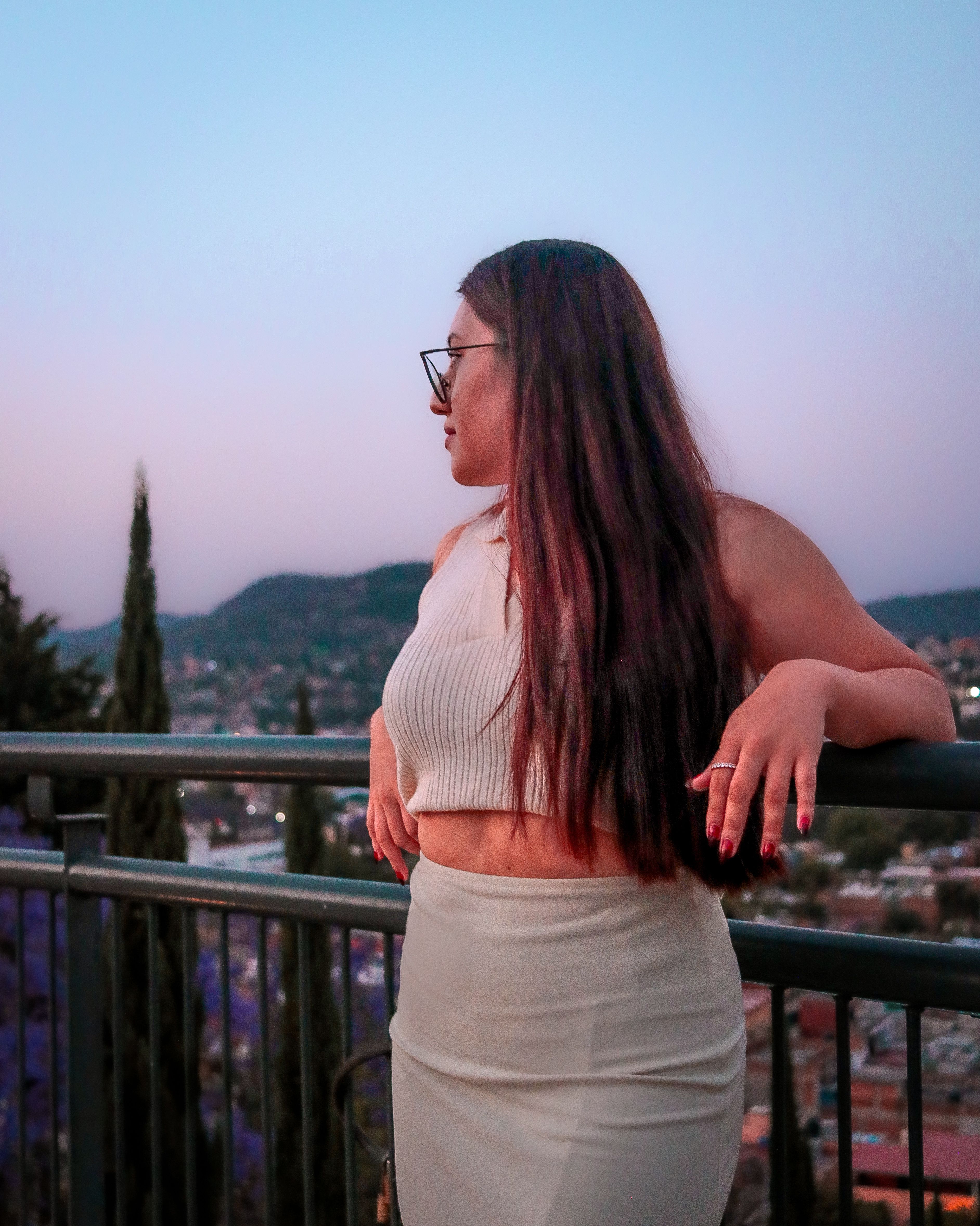 Woman Posing Leaning against Railing Looking Away · Free Stock Photo