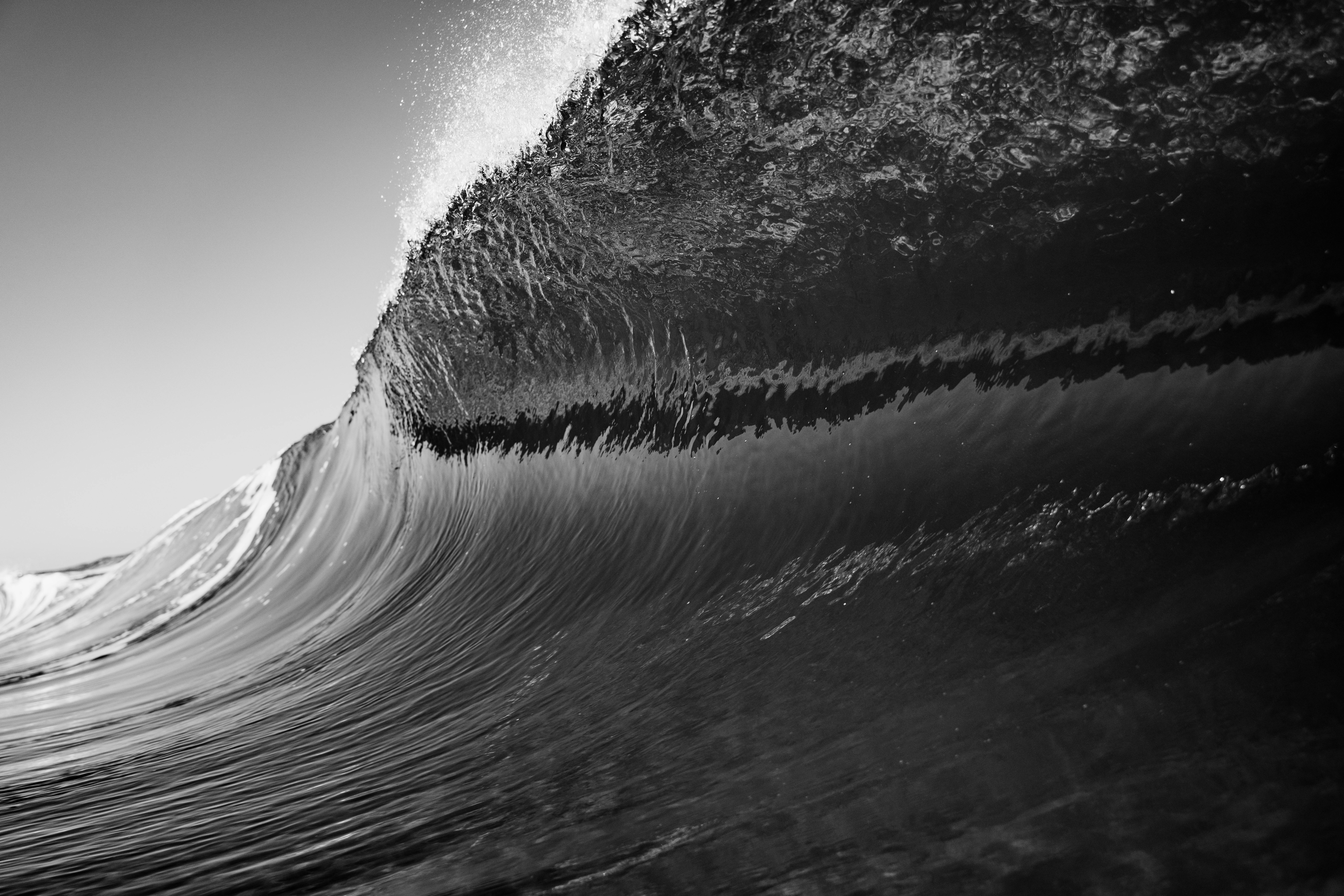 Captivating black and white photo capturing a powerful ocean wave in dynamic motion.