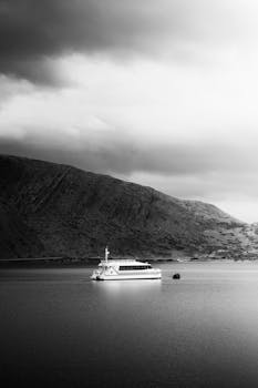 A ferry sails peacefully on the calm waters near Puerto Natales, Chile.
