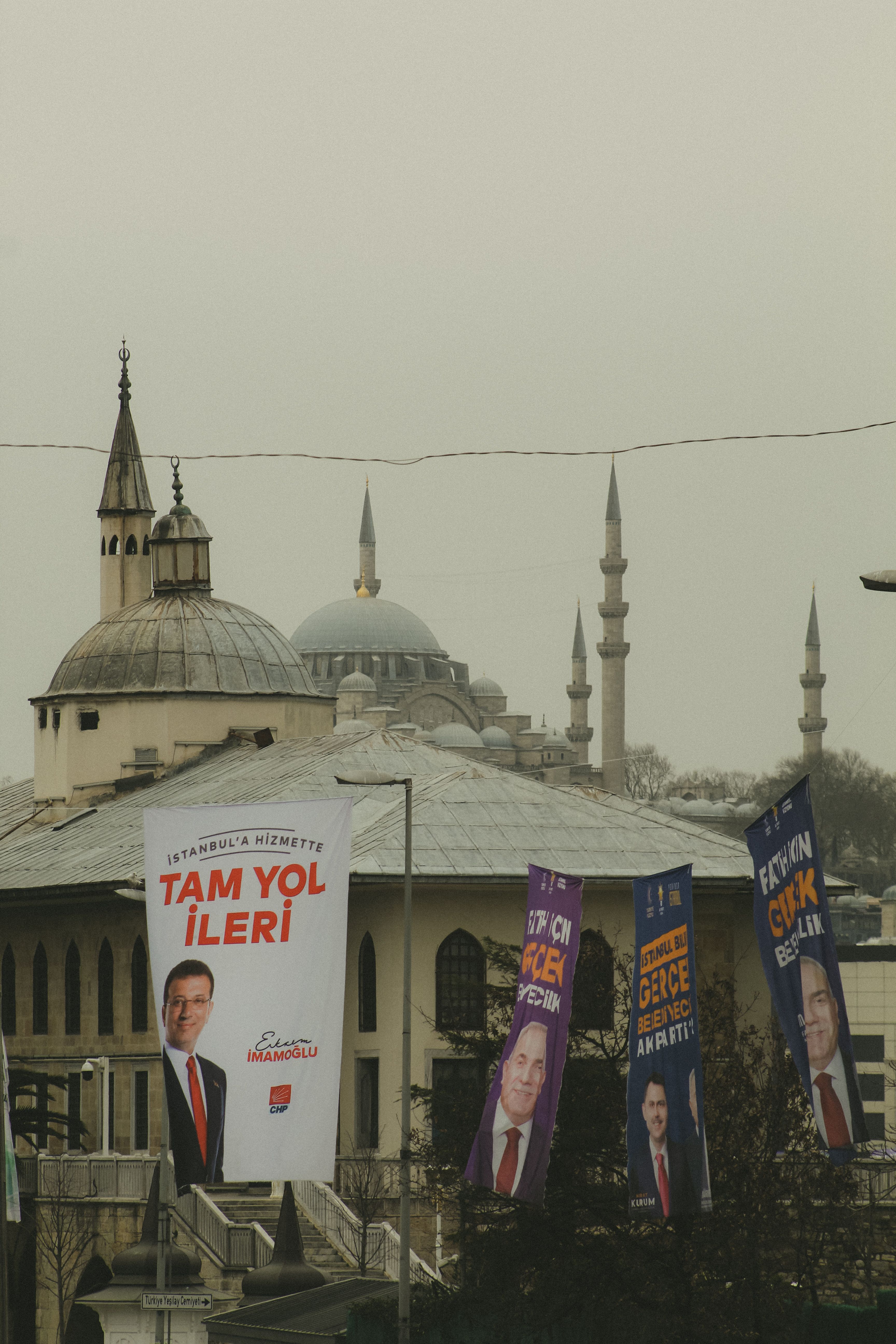 Istanbul street view featuring election posters and iconic Ottoman architecture.