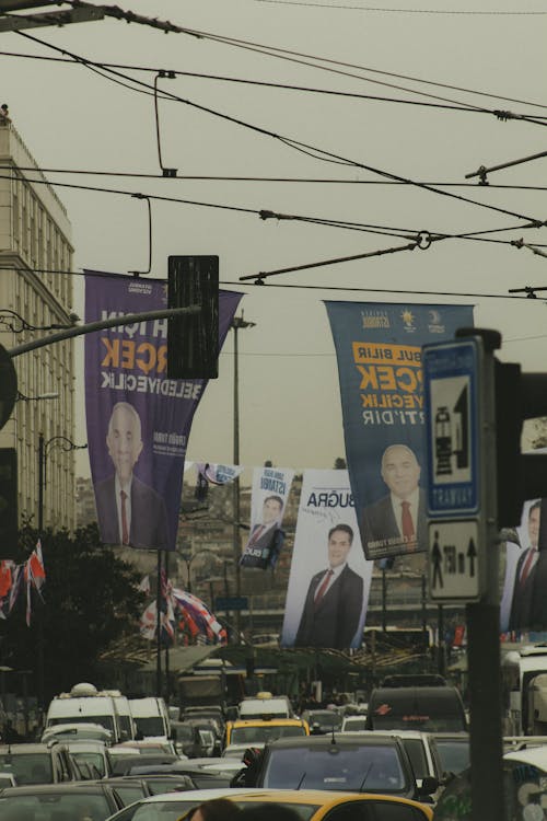 A city street with a lot of traffic and billboards