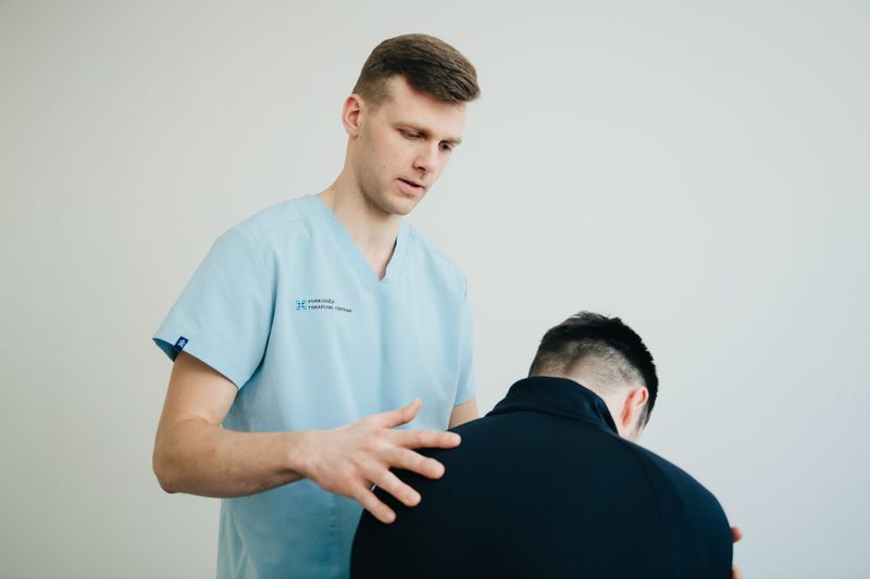 Physiotherapist assessing a patient's posture