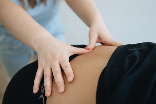 A woman is getting a massage on her back