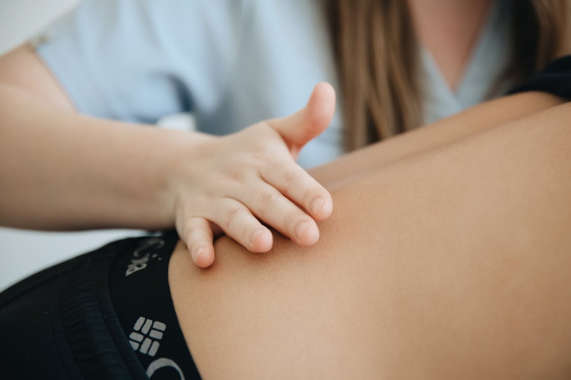 A woman is getting a massage on her back