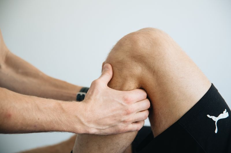 Physiotherapist treating knee and joint pain