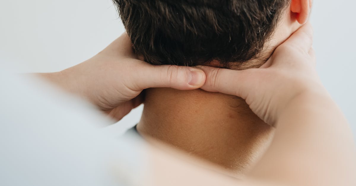 A person receiving a neck massage with a focus on muscle tension and relaxation.