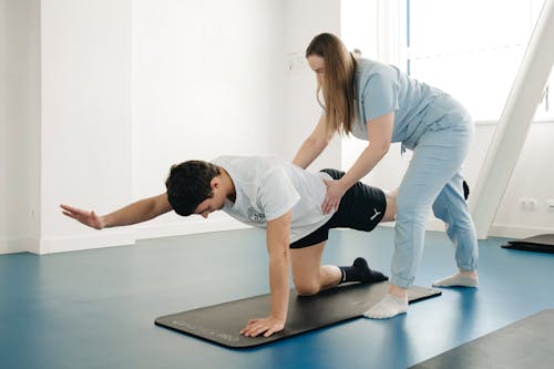 A woman doing a stretching exercise on a mat