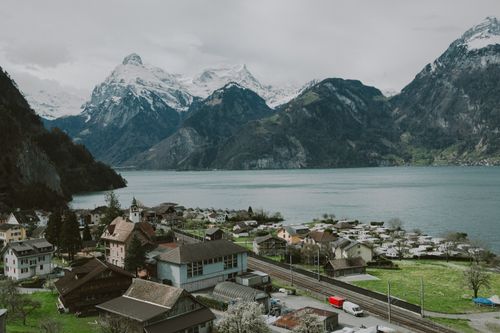 Free A stunning aerial village view with Lake Lucerne and Swiss Alps in the background, perfect for travel and nature themes. Stock Photo