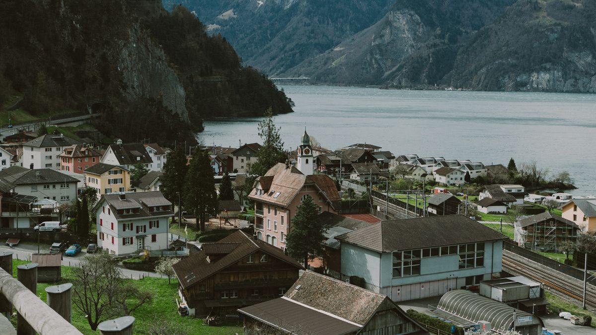 Lakeside village beneath snow-capped mountains in the Alps