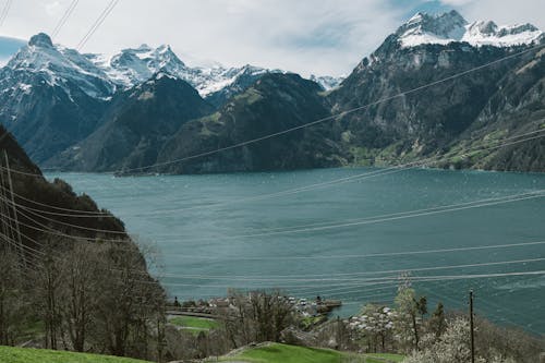 A view of a lake and mountains from a hill