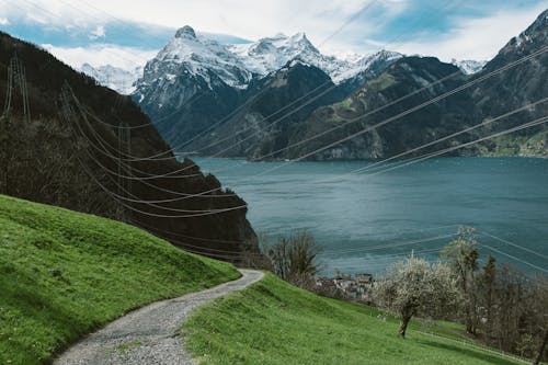 A path leading to a lake and mountains